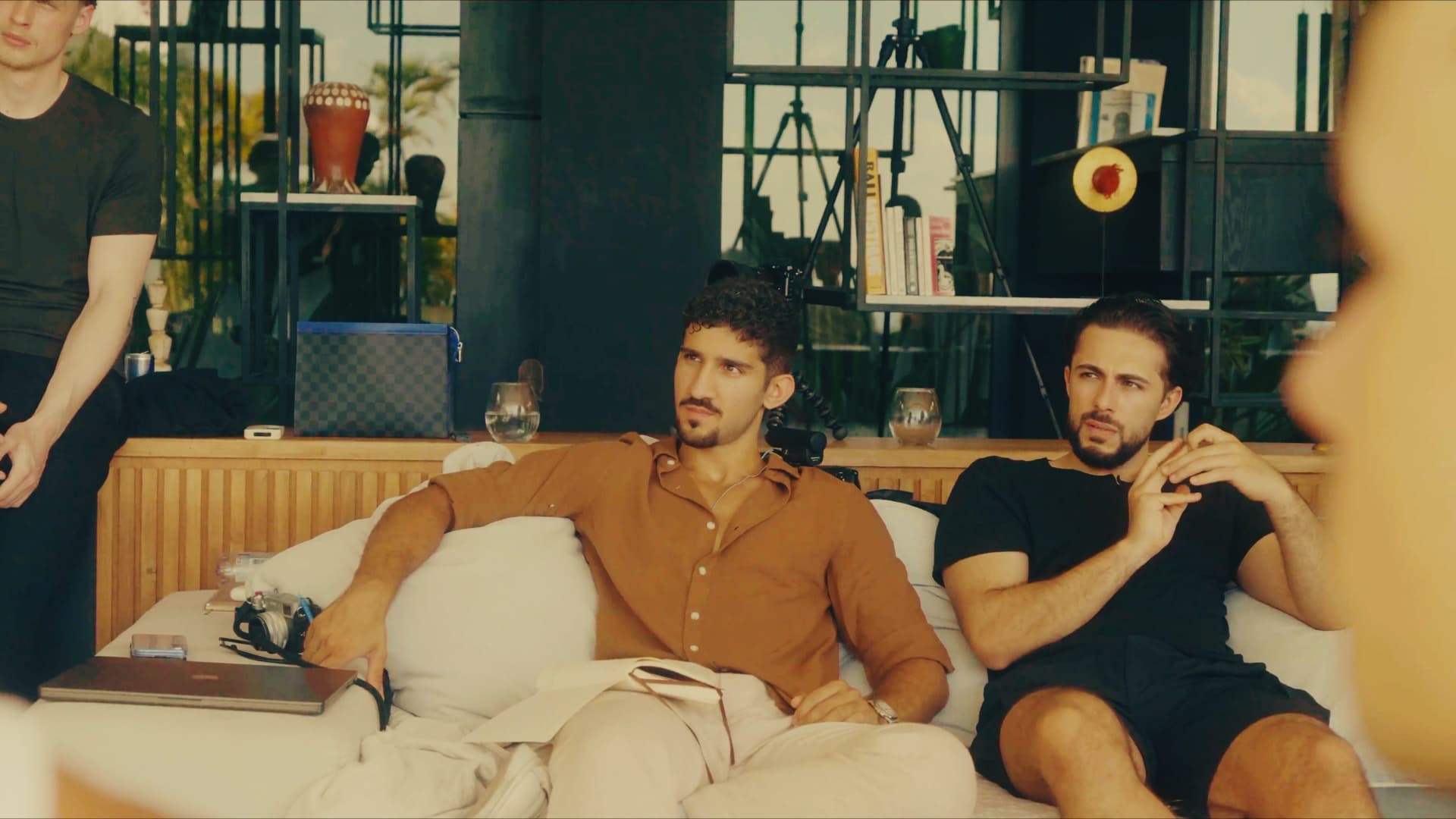 Alex listening to an operator at a villa session, notebook open.