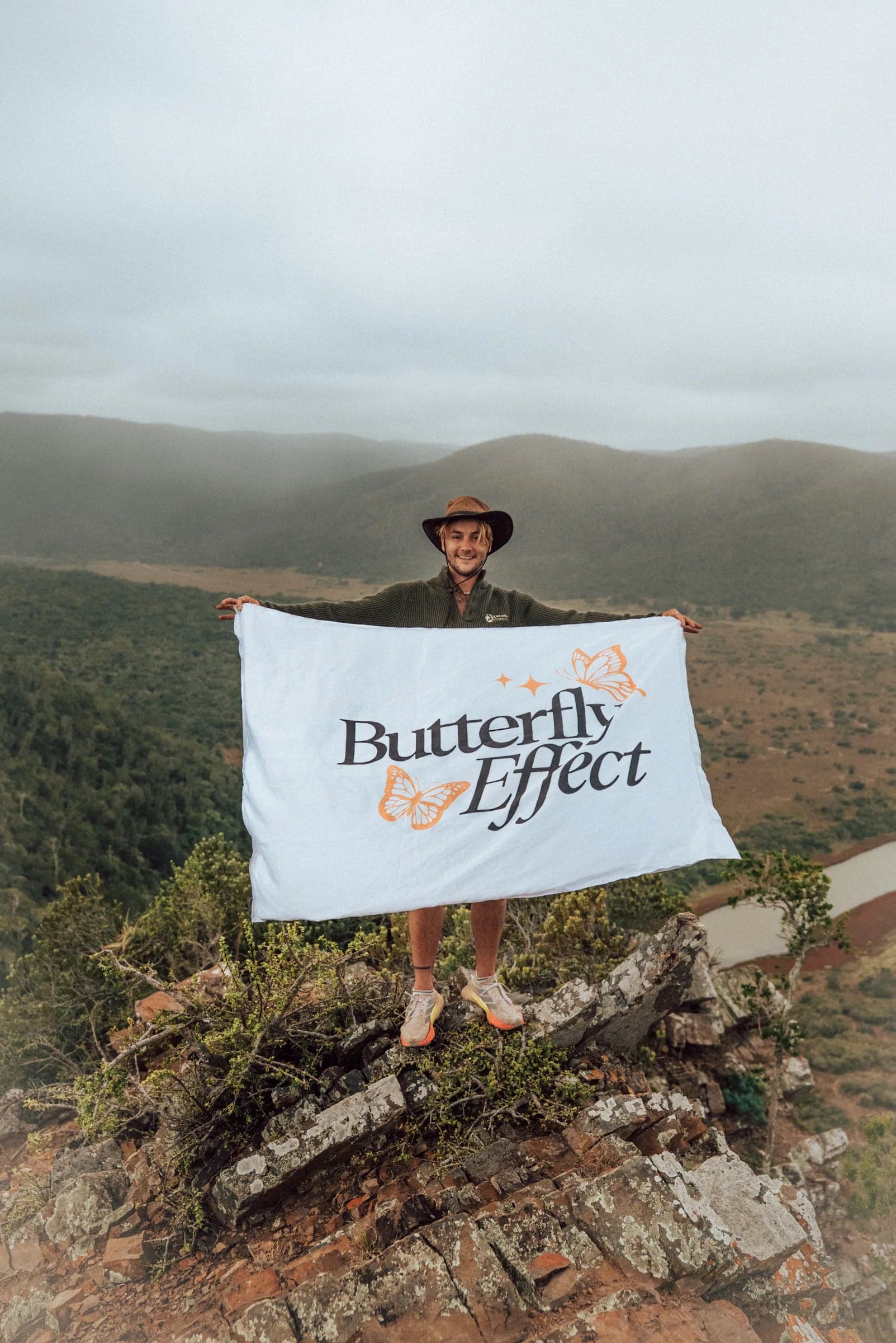 Lee Hutchinson holding the Butterfly Effect flag on a hillside