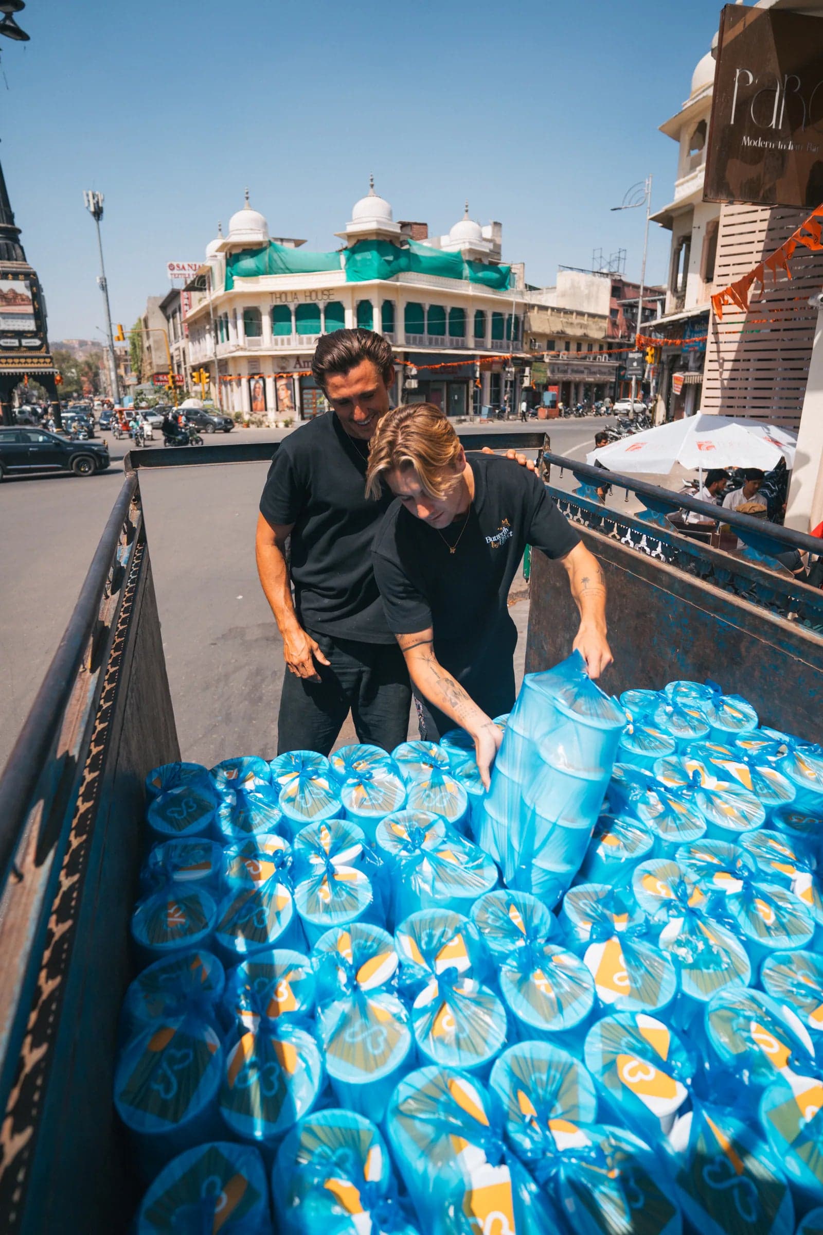 Meal parcels being unloaded from a truck during a giving trip