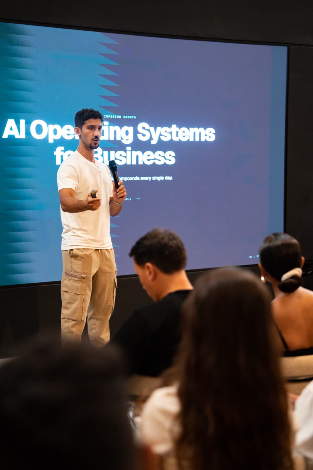 Alex Kaymakanov on stage presenting the Imperium operating system.